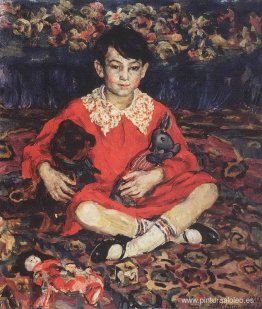 Retrato de una niña sentada sobre una alfombra colorida con los