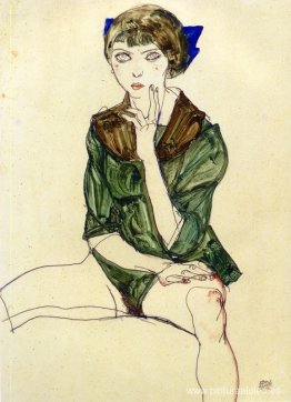 Mujer sentada con una blusa verde Mujer sentada con una blusa verde