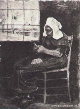 Mujer pelando patatas cerca de una ventana Mujer pelando patatas cerca de una ventana