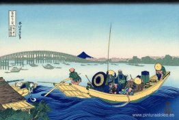 Puesta de sol cruzando el puente Ryogoku desde la orilla del río Puesta de sol cruzando el puente Ryogoku desde la orilla del río