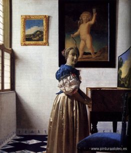 Una dama de pie ante un virginal Una dama de pie ante un virginal