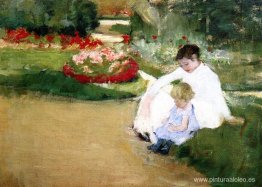 Mujer y niño sentados en un jardín. Mujer y niño sentados en un jardín.