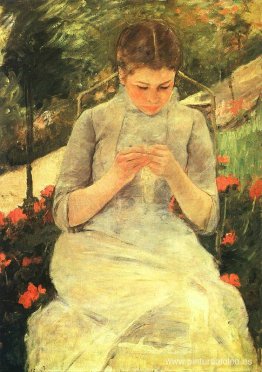 Mujer joven cosiendo en el jardín. Mujer joven cosiendo en el jardín.