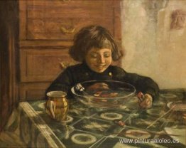 Un niño sentado en una mesa. Un niño sentado en una mesa.